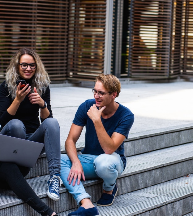 three persons sitting on the stairs talking with each other 1438072