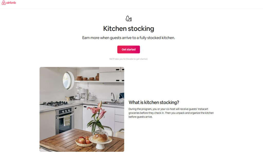 A screenshot of Airbnb’s “Kitchen stocking” pilot page. The page headline reads “Kitchen stocking,” with a description saying hosts can earn more when guests arrive to a fully stocked kitchen. A button labeled “Get started” appears below. The lower section shows a bright, modern kitchen with white cabinets, a gas stove, wooden table, and fresh groceries. A text block on the right explains that hosts or co-hosts receive guests’ Instacart groceries before check-in, then unpack and organize them.
