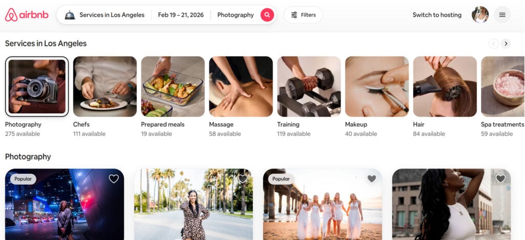 A screenshot of Airbnb’s “Services in Los Angeles” page showing service categories displayed in a horizontal carousel. Categories include Photography, Chefs, Prepared Meals, Massage, Training, Makeup, Hair, and Spa Treatments, each with an availability count underneath. Below the carousel, individual photography service listings appear with sample images and “Popular” tags.
