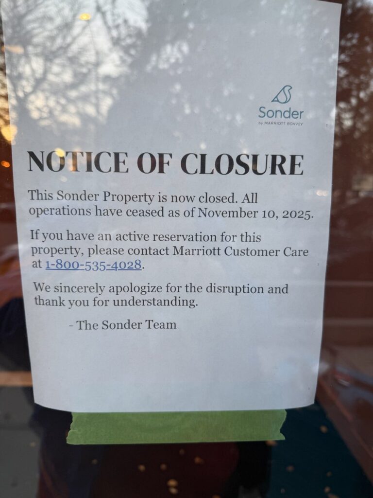 Sonder Shutdown: A Sudden End to a High-Profile Hospitality Experiment 2 Printed “Notice of Closure” sign taped to a door at a Sonder property. The notice states that the property is closed and all operations ceased as of November 10, 2025. It directs guests with active reservations to contact Marriott Customer Care at a listed phone number and includes an apology signed by “The Sonder Team.”