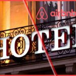 Airbnb hotels concept image showing the Airbnb logo over a traditional hotel sign, symbolizing Airbnb’s expansion into hotel listings.