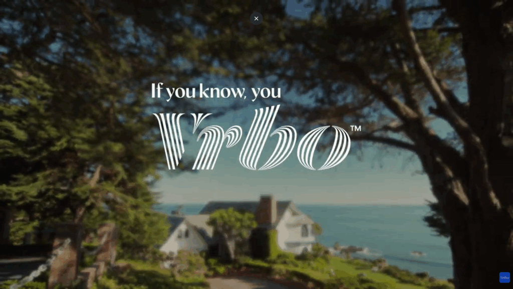 A still from the quiet debut of Vrbo’s 'If you know, you Vrbo' commercial. The campaign leans into aspirational imagery and brand fluency rather than comparative advertising. A screenshot from the 2026 Vrbo commercial featuring the new tagline 'If you know, you Vrbo' overlaid on a scenic coastal vacation rental home.