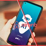Person holding a smartphone displaying an AI loading screen and the Airbnb logo, illustrating the new Airbnb AI strategy.