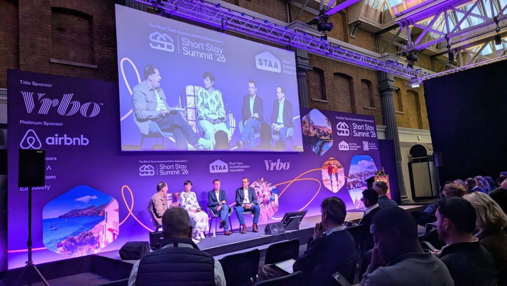 Short Stay Summit 2026 opening data panel with Beyond, Guesty, PriceLabs, AirDNA discussing short term rental pricing strategy 2026.