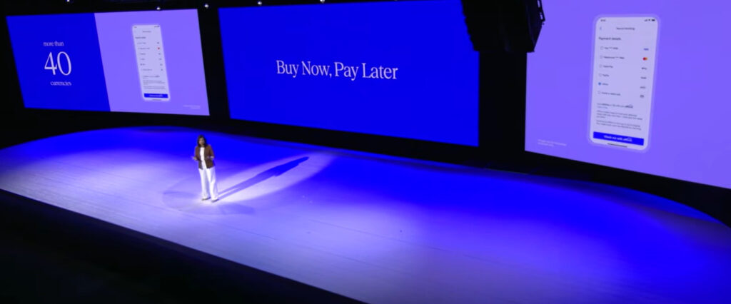 Vrbo Search Is Becoming Conversational. What That Means for Hosts 4 Executive speaker at Expedia Explore 2026 presenting the Buy Now, Pay Later checkout expansion for travel booking.